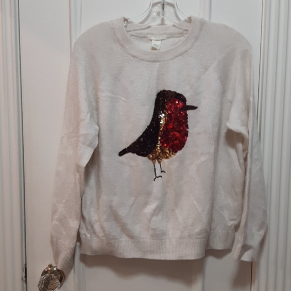 Sequin bird on a knit sweater